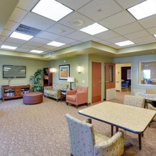 A cozy and inviting lounge area designed for relaxation and waiting, featuring comfortable seating and a warm ambiance.