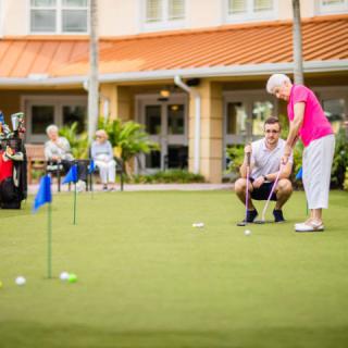 Seniors enjoying a leisurely day on the putting green.