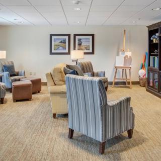 A cozy lounge area with comfortable seating and a bookshelf.