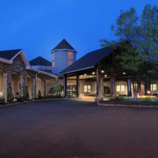 A welcoming hotel entrance illuminated at dusk.