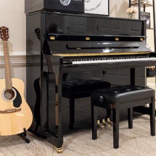 A stylish black piano accompanied by an acoustic guitar, perfect for a music-filled space.