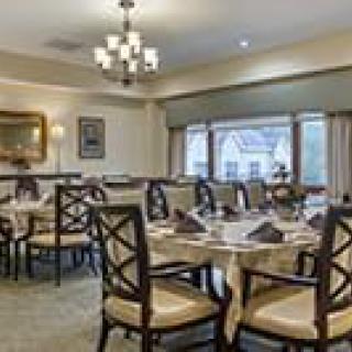 A well-appointed dining area with neatly arranged tables and elegant lighting.