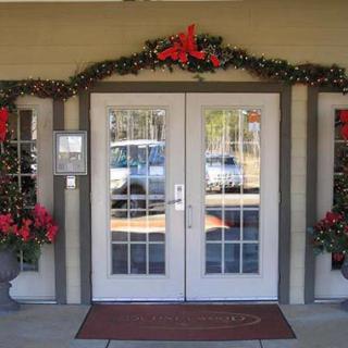 A festively decorated entrance with Christmas wreaths and garlands.