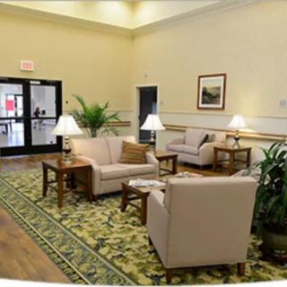 A cozy lobby area with comfortable seating, decorative lighting, and indoor plants.