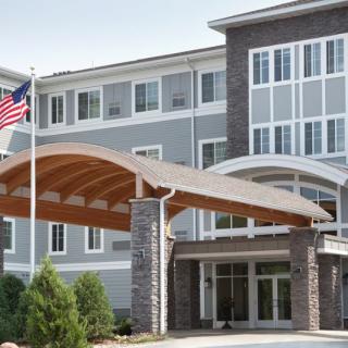 A modern building entrance with an American flag prominently displayed.