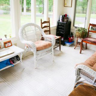 A cozy sunroom with wicker furniture and ample natural light.