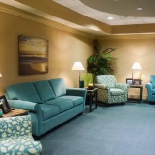 A cozy living room with comfortable seating and warm lighting.