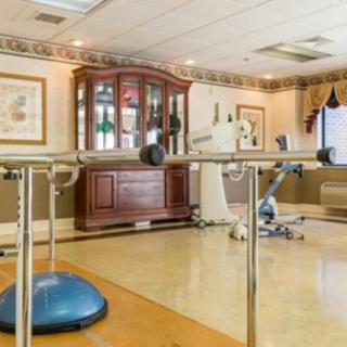 A rehabilitation room equipped with exercise and physical therapy tools.