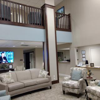 A spacious and modern living room area with comfortable seating and an open design.