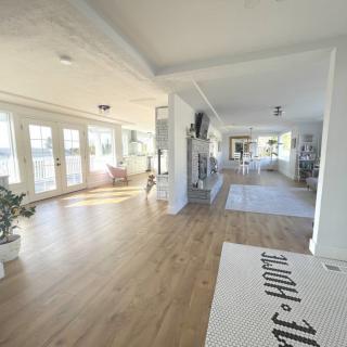 A bright and spacious living room with modern decor and wooden flooring.
