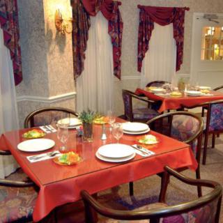A cozy restaurant interior with tables set for dining.