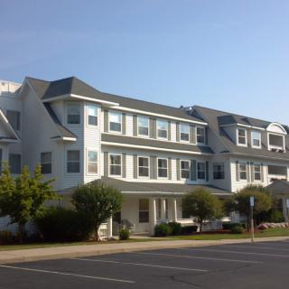 A row of residential apartment buildings under a clear blue sky.