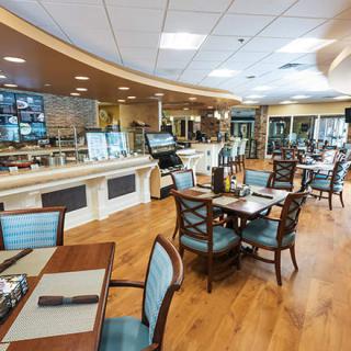 A modern restaurant interior with neatly arranged tables and chairs.