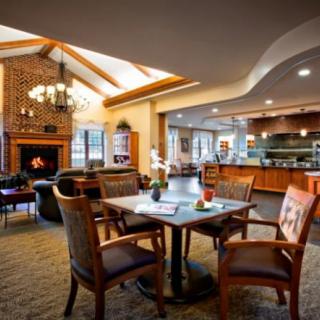 A cozy lounge area with comfortable seating and a warm fireplace.