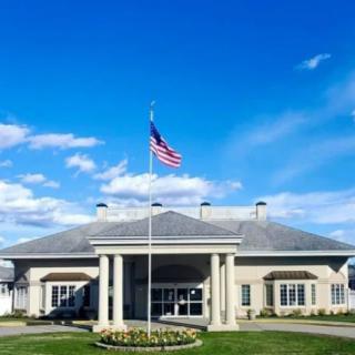 A building with an American flag on a bright, sunny day.