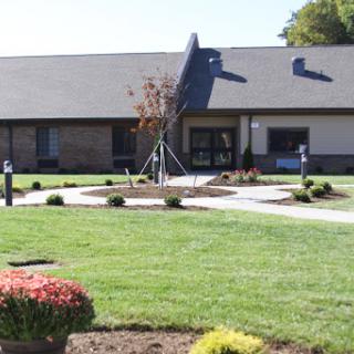A well-maintained building surrounded by landscaped gardens.