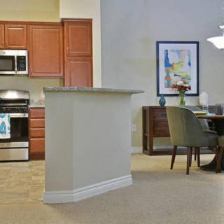 A modern kitchen and dining area with stainless steel appliances and contemporary furnishings.