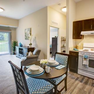 Modern open-layout apartment with a kitchen, dining area, and living room.