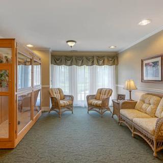A cozy living room with comfortable seating and natural light from a large window.