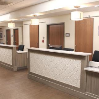 A modern reception area in a healthcare setting, featuring multiple desks and an inviting atmosphere.