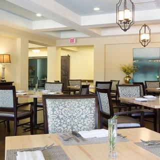 A modern dining room with elegant furnishings and ambient lighting.