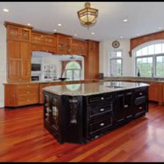 A spacious modern kitchen with an island and wooden cabinetry.