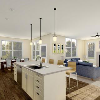 A modern open-concept kitchen and living room with a central island and pendant lighting.