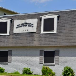 Exterior of a medical rehabilitation center building on a sunny day.