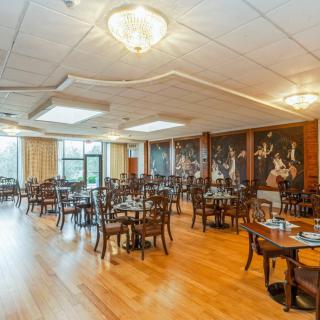 An elegant indoor dining area with wooden flooring and stylish decor.