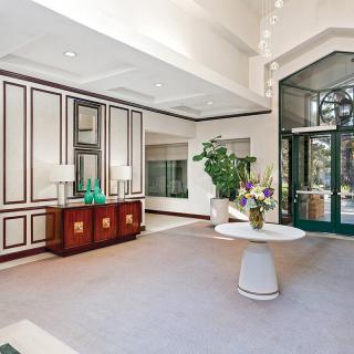 A well-decorated lobby area with elegant furniture and floral arrangements.