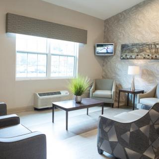 A modern living room with ample seating, natural light, and stylish decor.