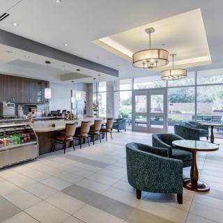 A modern cafe interior with seating area and counter.