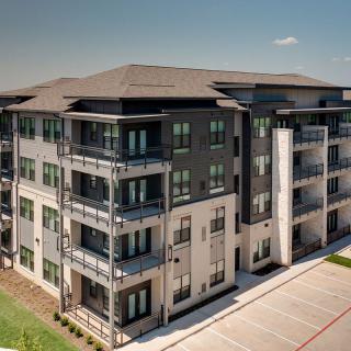 A modern apartment building with multiple floors and balconies.