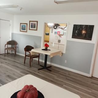 A cozy dining area featuring a small table, chairs, and decorative elements.