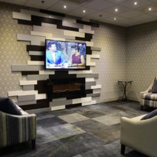 A modern living room with a stylish decorative wall and television.