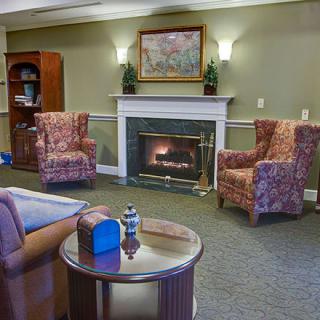 A cozy living room with a fireplace and comfortable seating.