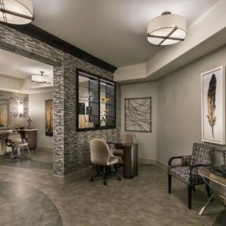 A modern waiting area with stylish seating, artwork, and contemporary lighting.
