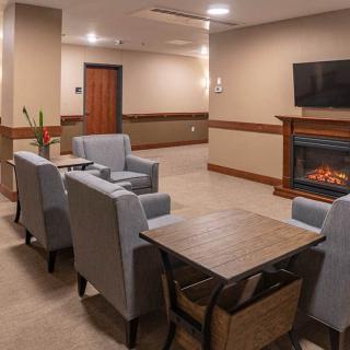 Cozy lounge area with modern seating and a fireplace.