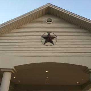 A charming home exterior featuring a star emblem on the facade.