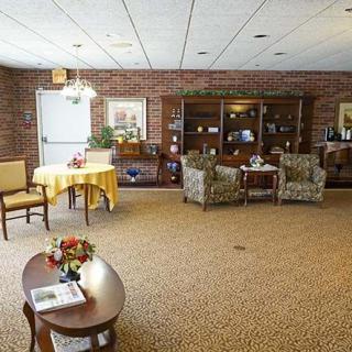 A cozy living room with comfortable seating and a brick wall.