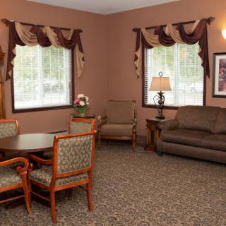 A cozy living room with comfortable seating, adorned with elegant curtains and a warm atmosphere.