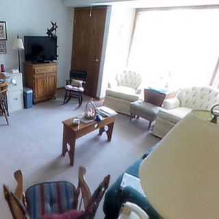 A cozy living room with various furniture pieces, including a sofa, chairs, and a coffee table.