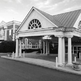 A stylish hotel entrance captured in black and white, showcasing its architectural design.