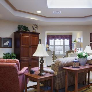 A cozy living room with comfortable seating, decorative elements, and natural light.