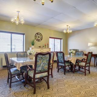 A spacious dining room with elegant furniture and decorative elements.