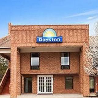 The exterior of a Days Inn hotel with brick architecture and double-door entrance.