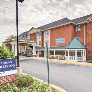 A senior living facility with a brick exterior and covered entrance.