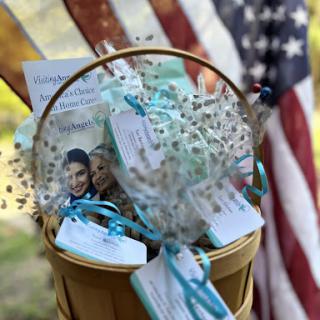 A beautifully decorated basket filled with party favors and mementos, set against the backdrop of an American flag.