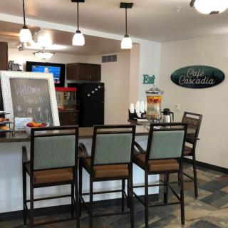An inviting bar area with high chairs and cozy lighting, perfect for a casual hangout.