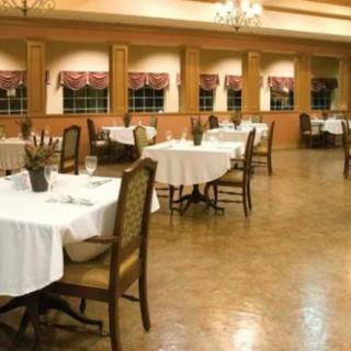An empty restaurant dining area with neatly arranged tables and chairs.